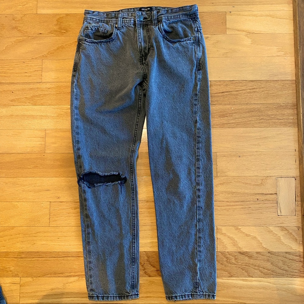 Black Single Legged Ripped Jeans.